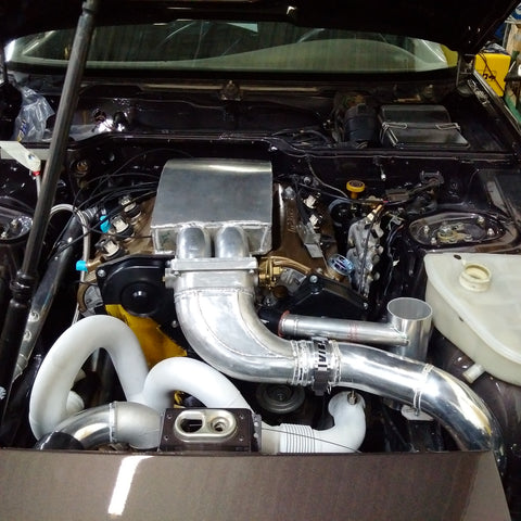 Mazda powered Porsche with fabricated intake and exhaust manifolds, as well as coolant swirl pot.